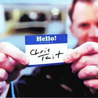 Chris Tait holding a handwritten greeting